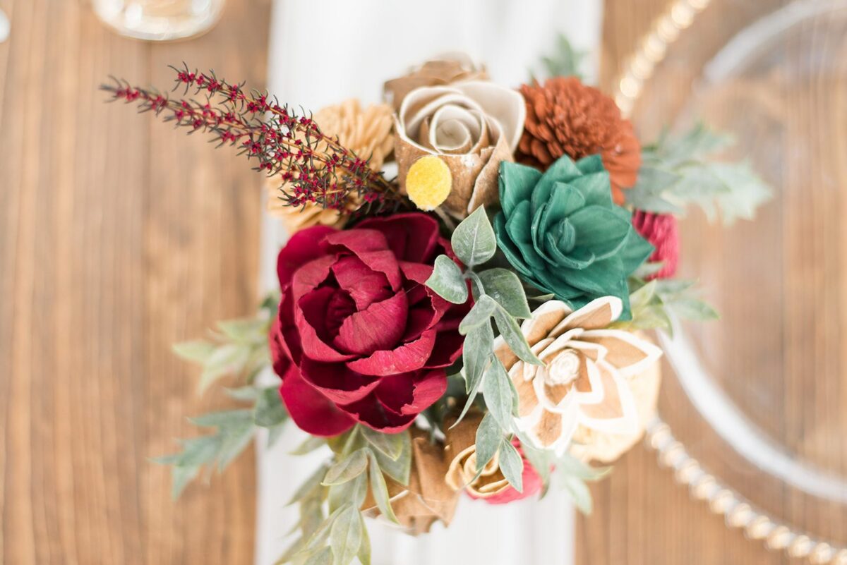 Wooden floral bouquet centerpiece at a Florida wedding reception at The Red Barn at Bushnell