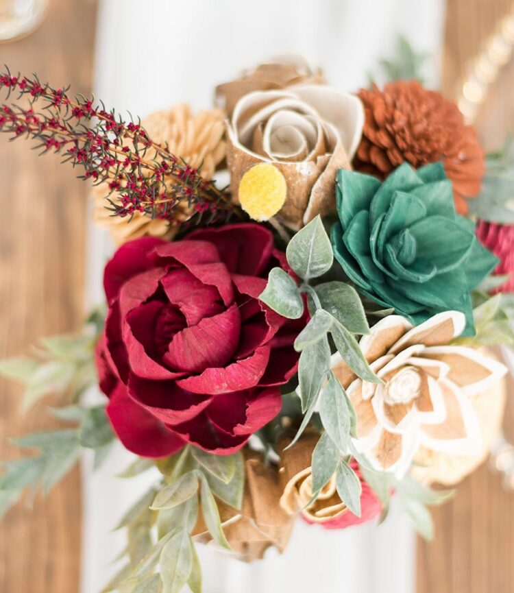 Wooden floral bouquet centerpiece at a Florida wedding reception at The Red Barn at Bushnell