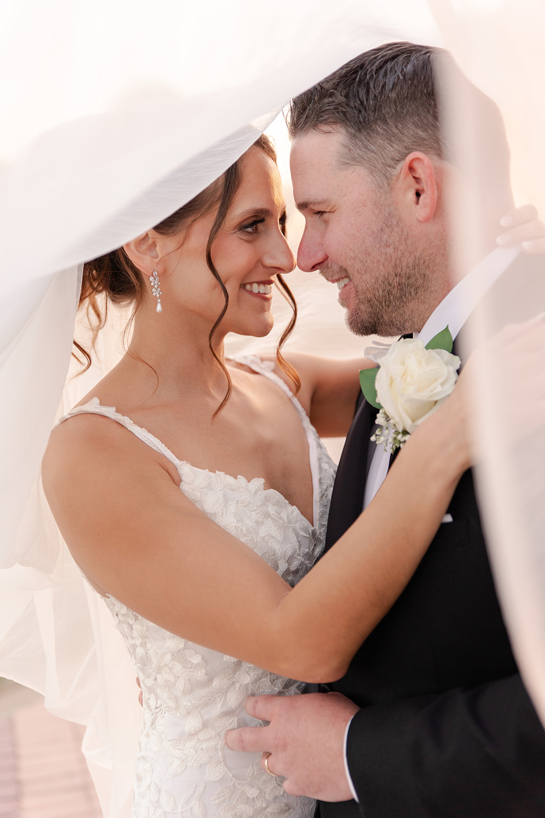 Intimate couple portrait behind veil